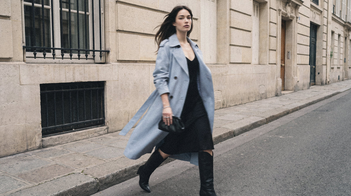 Woman walking down a Parisian street in a sky blue Majestique Paris trench coat